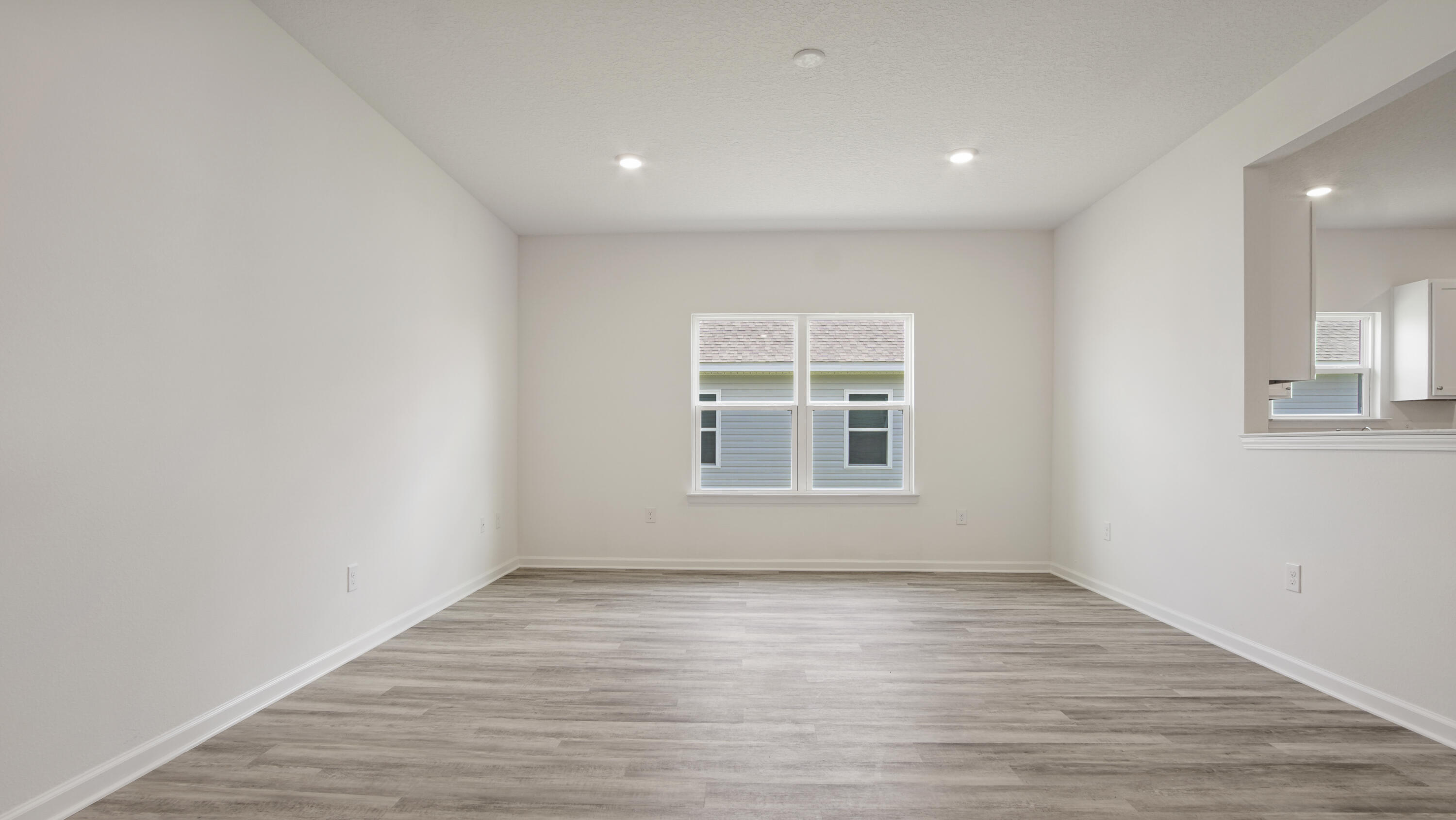205 Huckleberry Street Freeport, FL 32439 - Photo 5 of 32 an empty room with wooden floor and windows