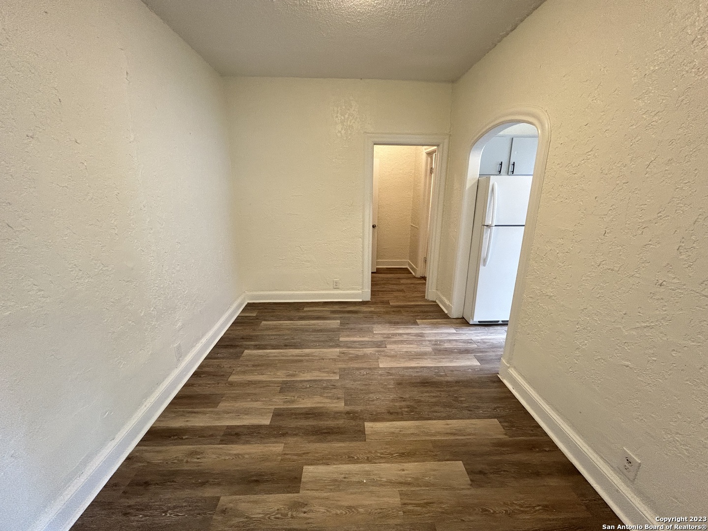 1625 McCullough Avenue, Unit 8 San Antonio, TX 78212 - Photo 3 of 5 a view of an empty room with wooden floor