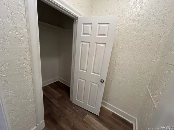 an empty room with wooden floor