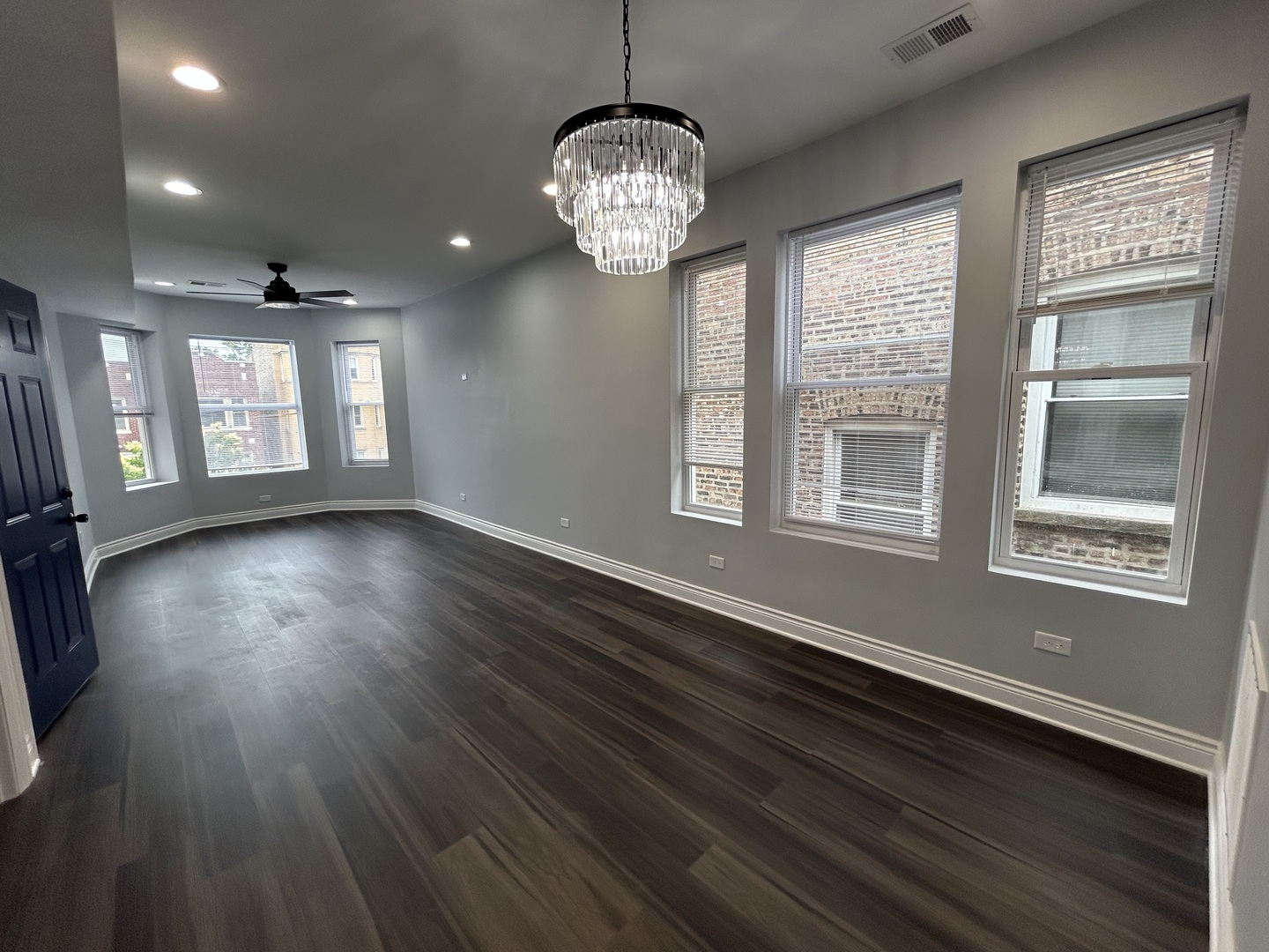 7940 South Carpenter Street, Unit 2 Chicago, IL 60620 - Photo 9 of 34 a view of an empty room with wooden floor and a window
