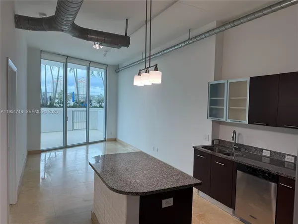 a kitchen with a sink a counter top space and cabinets