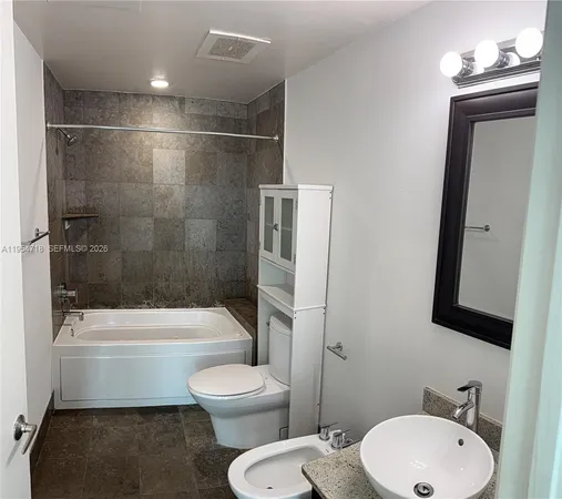 a bathroom with a toilet a sink and bathtub