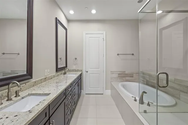 a spacious bathroom with a granite countertop tub sink and mirror