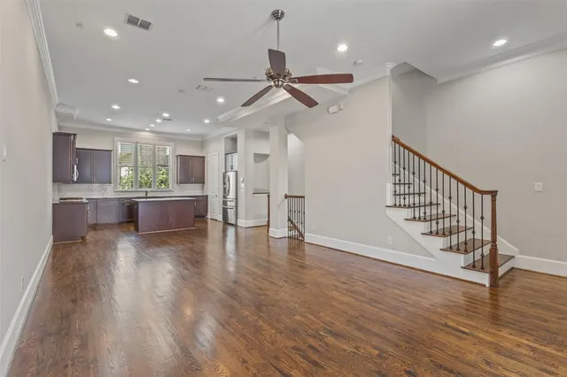 a view of a kitchen with a sink and wooden floor