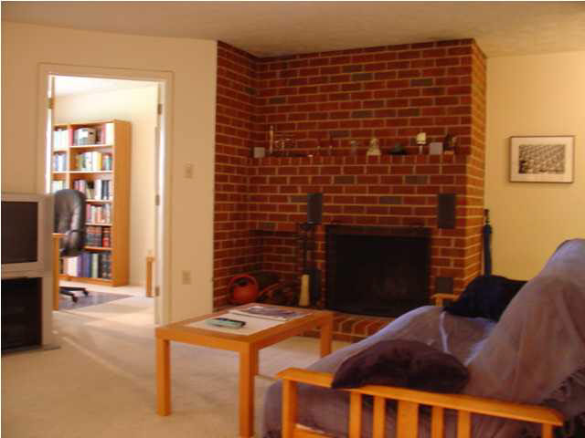 134 Turtle Creek Road, Unit 6 Charlottesville, VA 22901 - Photo 3 of 5 a brick building with a bench in front of it