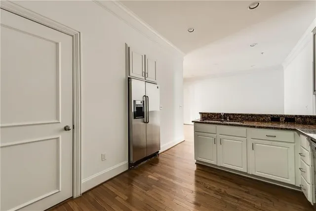 a kitchen with stainless steel appliances granite countertop a refrigerator and a stove