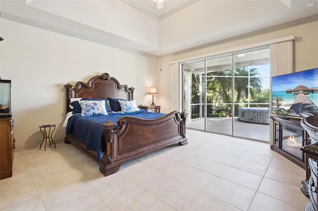 a bedroom with a bed and a large window