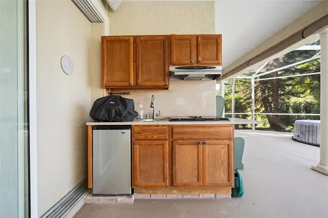 a kitchen with a refrigerator and a sink
