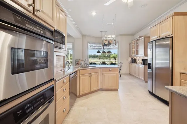 a kitchen with stainless steel appliances a refrigerator and a stove