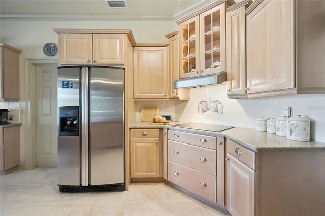 a kitchen with stainless steel appliances granite countertop a refrigerator and cabinets