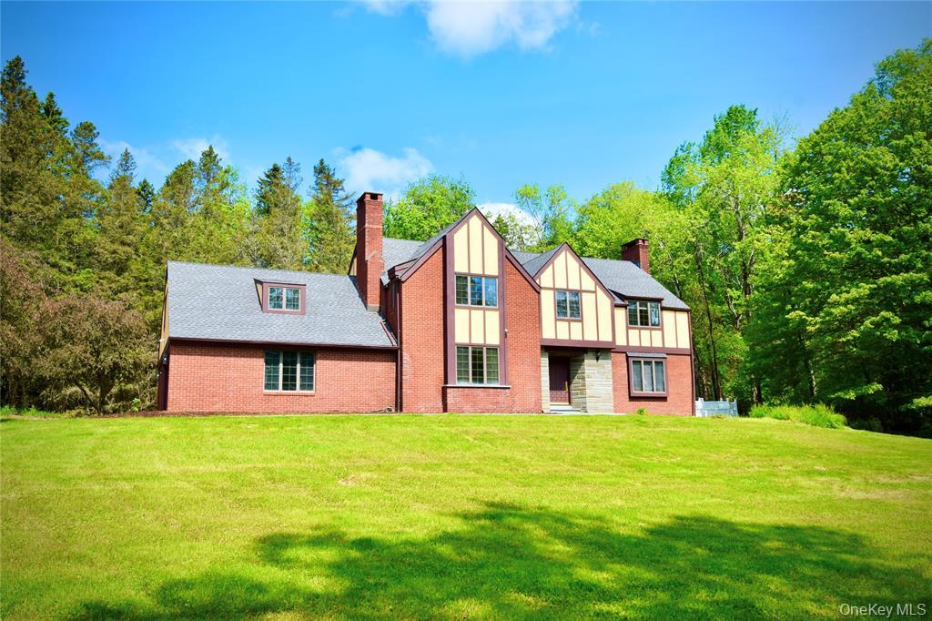 285 Goff Road Livingston Manor, NY 12758 - Photo 1 of 28 English style brick Tudor House with a chimney, board and batten siding, and a front lawn