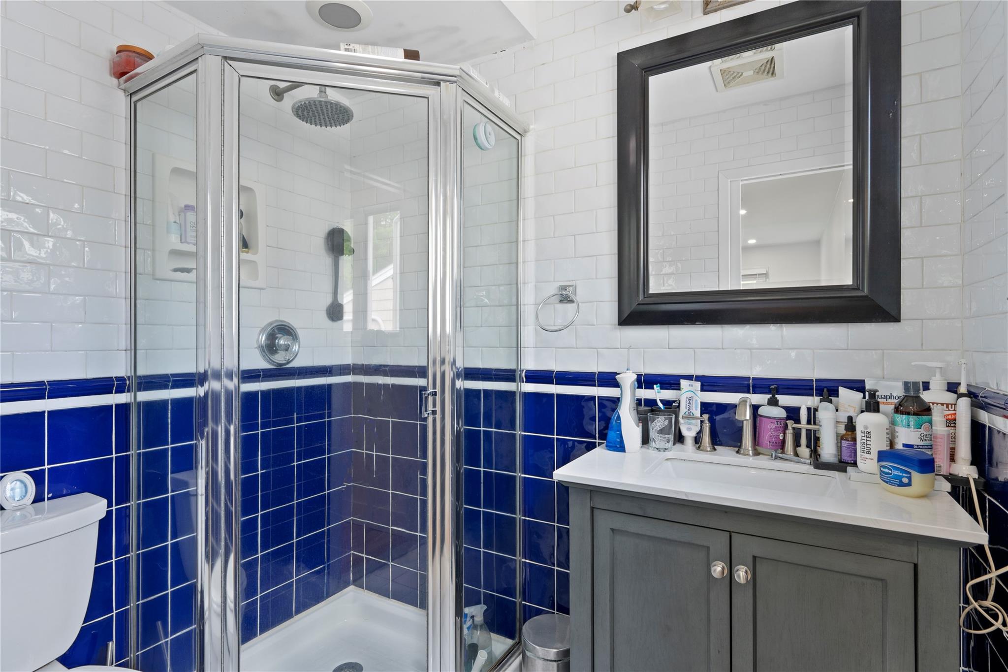 1 Bennett Avenue Huntington, NY 11746 - Photo 14 of 24 Bathroom with tile walls, vanity, and a stall shower