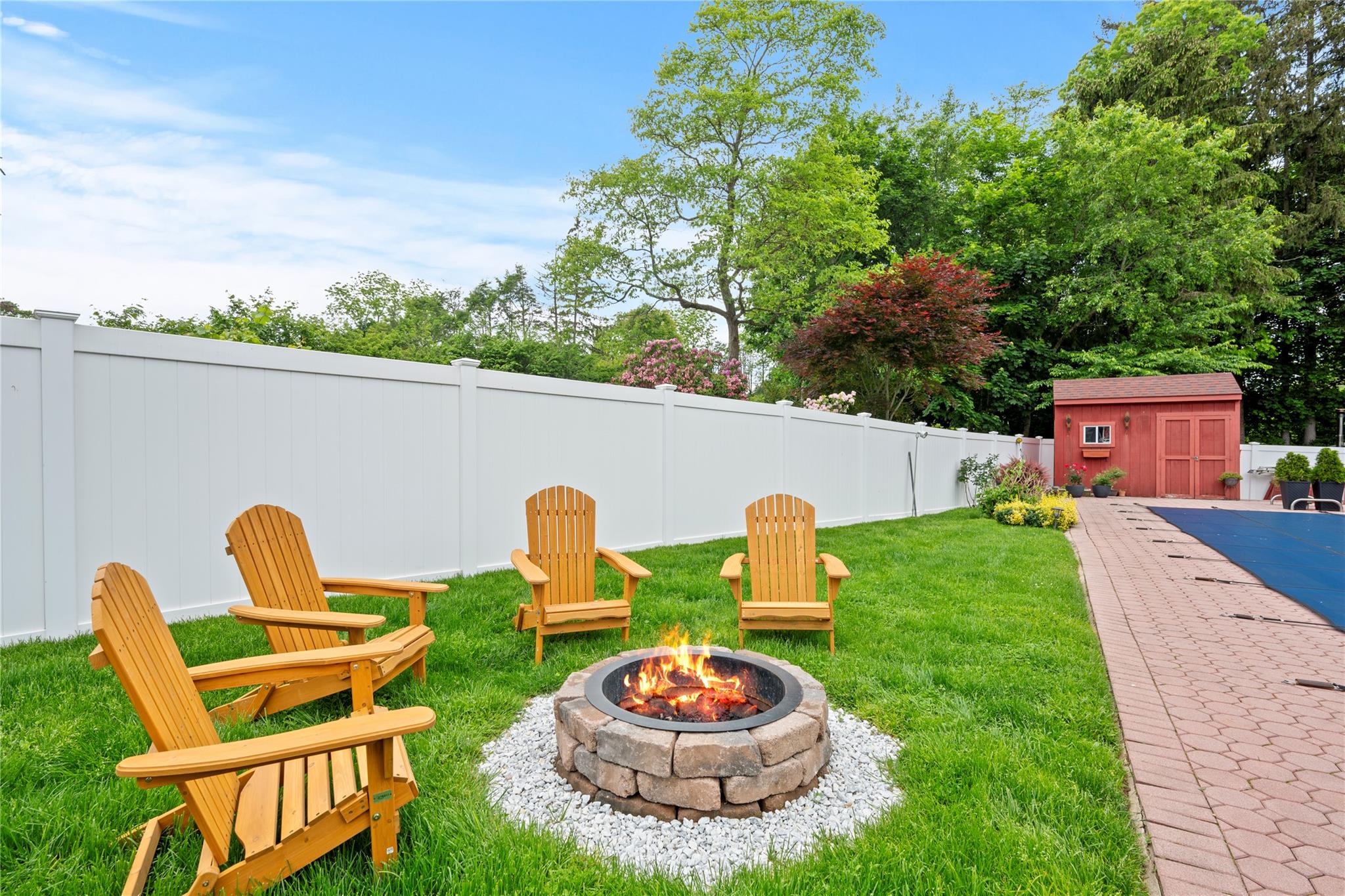 1 Bennett Avenue Huntington, NY 11746 - Photo 20 of 24 Fenced backyard with a fire pit and a storage unit