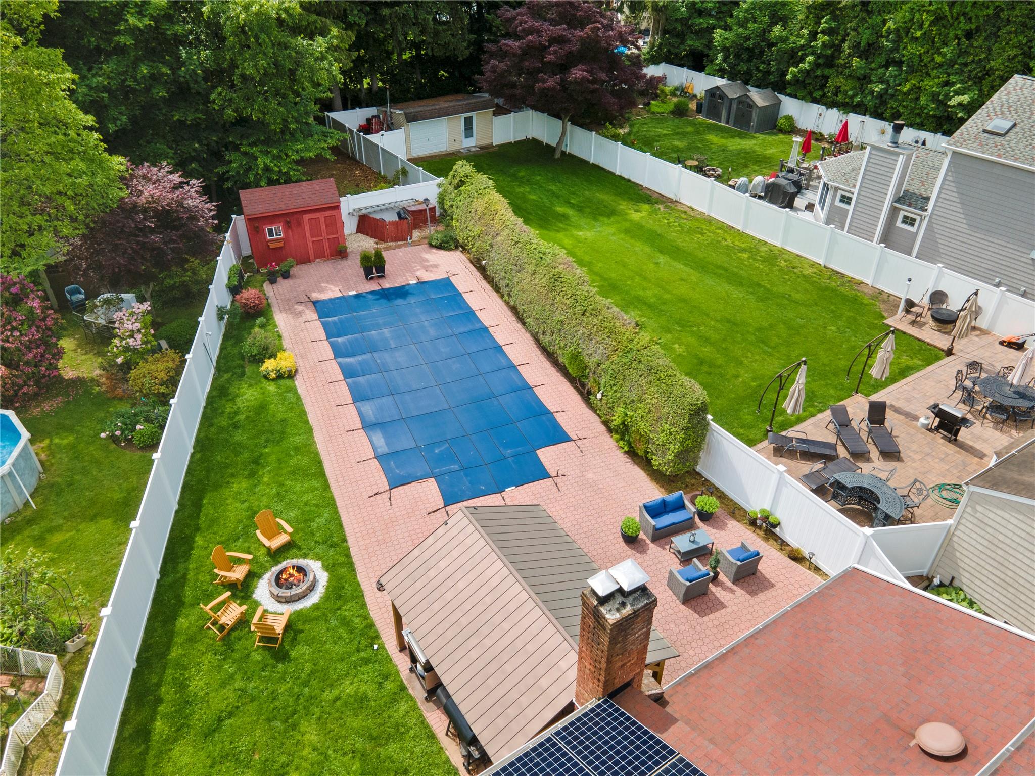 1 Bennett Avenue Huntington, NY 11746 - Photo 23 of 24 View of pool featuring a fenced backyard, a fire pit, and a storage shed