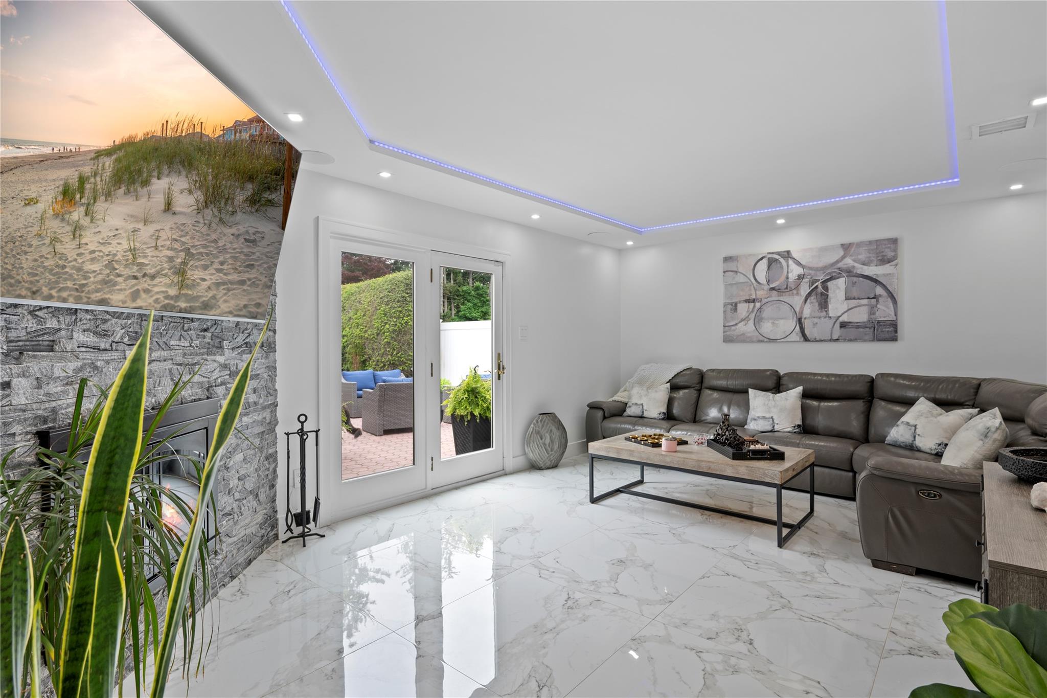 1 Bennett Avenue Huntington, NY 11746 - Photo 6 of 24 Living room with a tray ceiling, recessed lighting, a glass covered fireplace, and marble finish floors