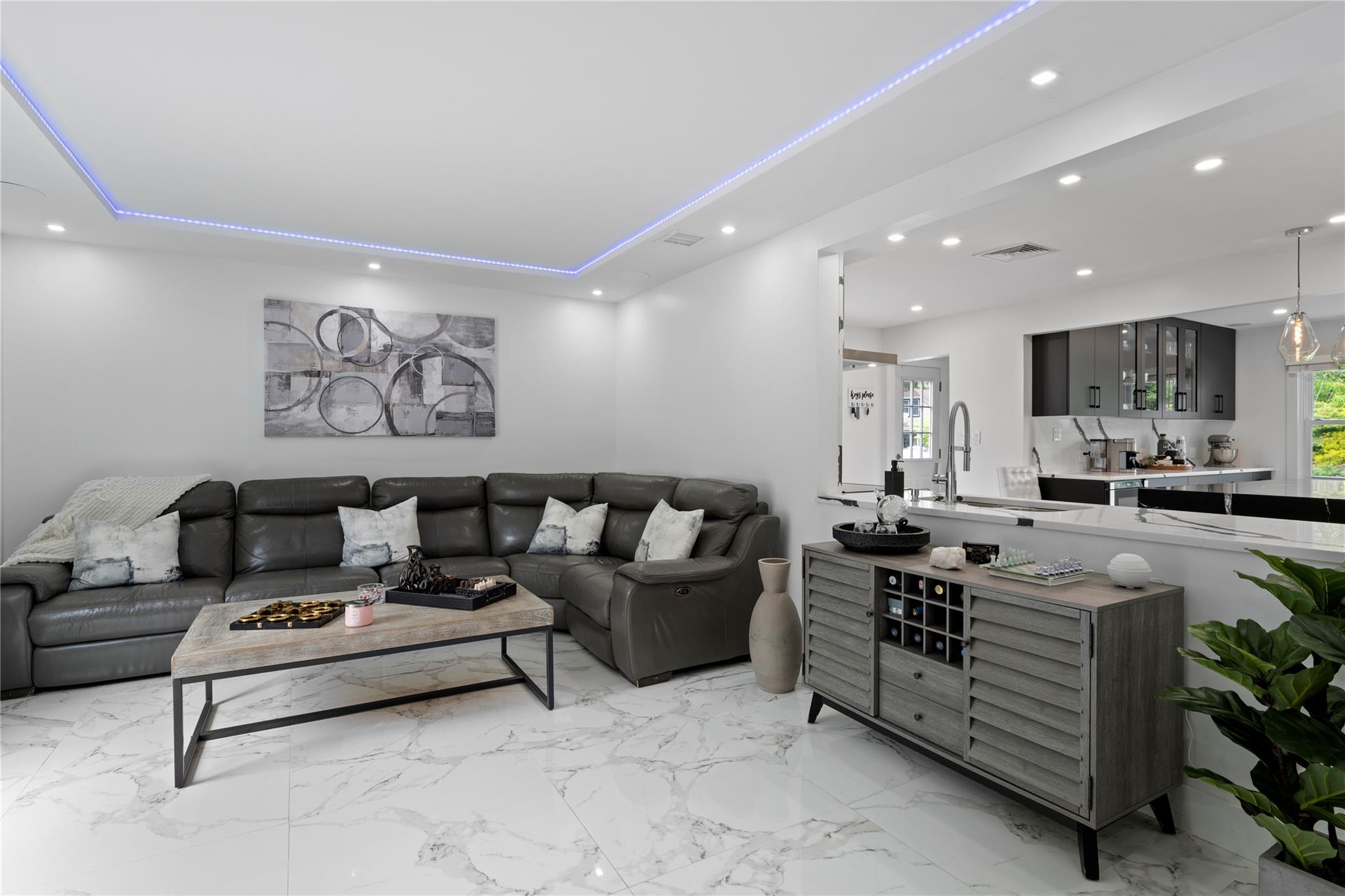 1 Bennett Avenue Huntington, NY 11746 - Photo 9 of 24 Living area with recessed lighting, light marble finish floors, and a tray ceiling