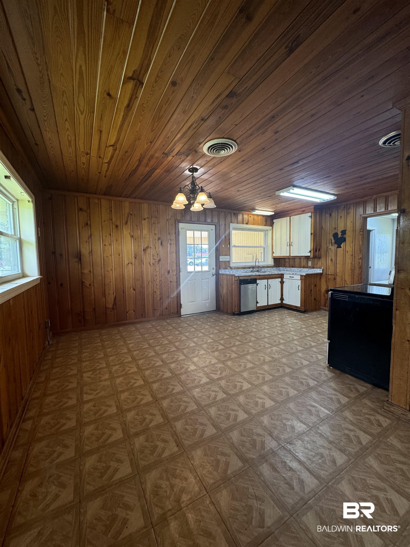 22720 Highway 31 Flomaton, AL 36441 - Photo 13 of 22 Kitchen with sink, wooden walls, wood ceiling, and dishwasher