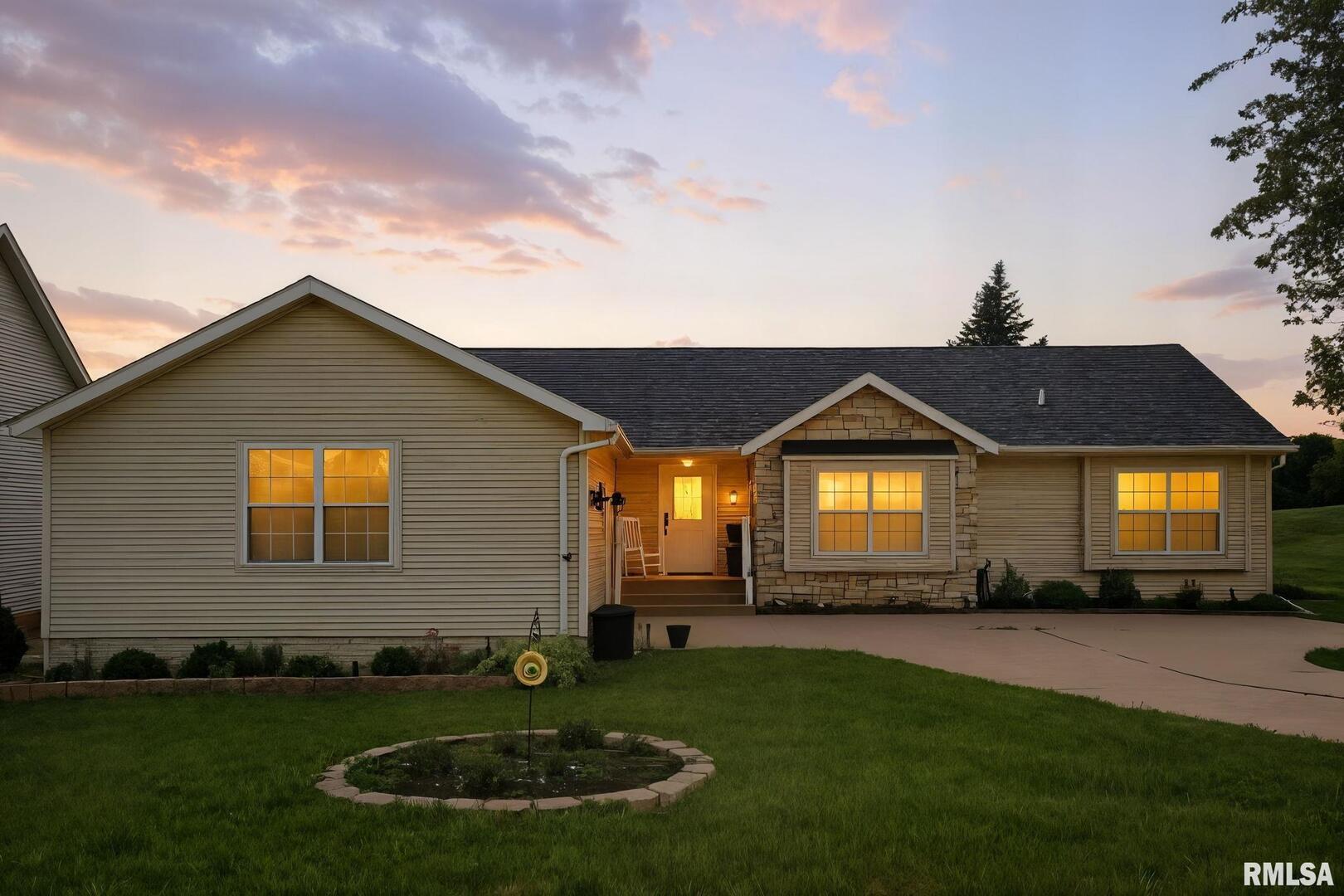 106 Valley View Drive Sherrard, IL 61281 - Photo 1 of 35 a front view of a house with a yard and garage