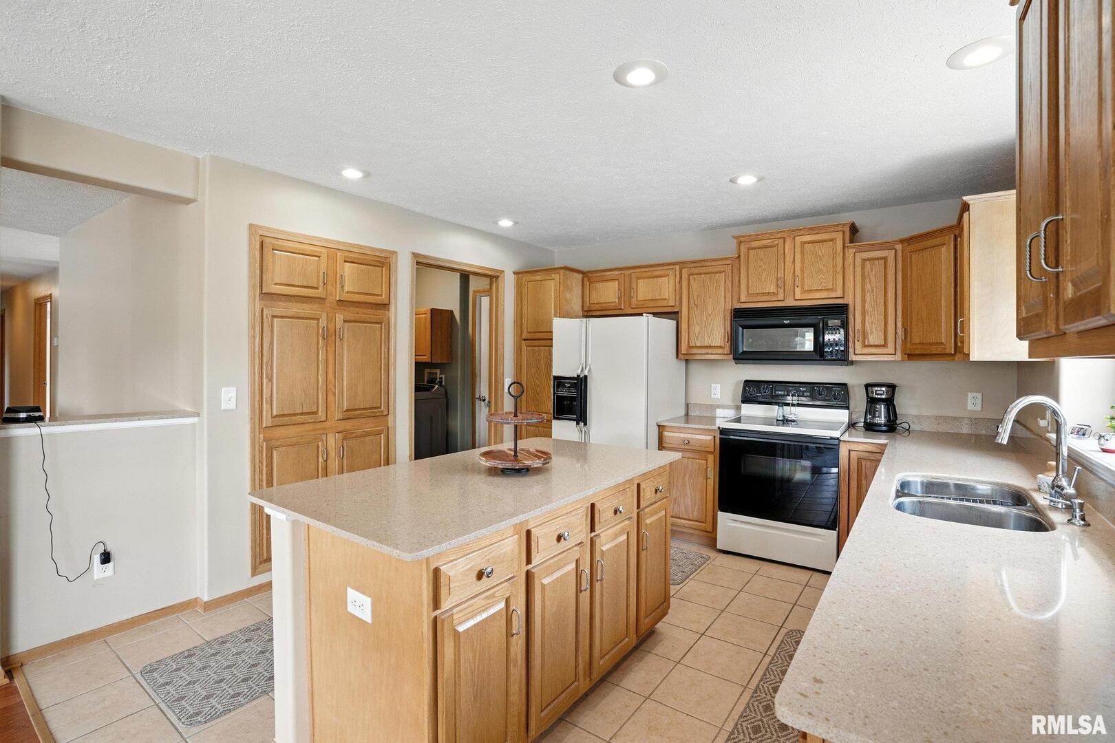 106 Valley View Drive Sherrard, IL 61281 - Photo 12 of 35 a kitchen with stainless steel appliances granite countertop a refrigerator a stove top oven a sink and dishwasher