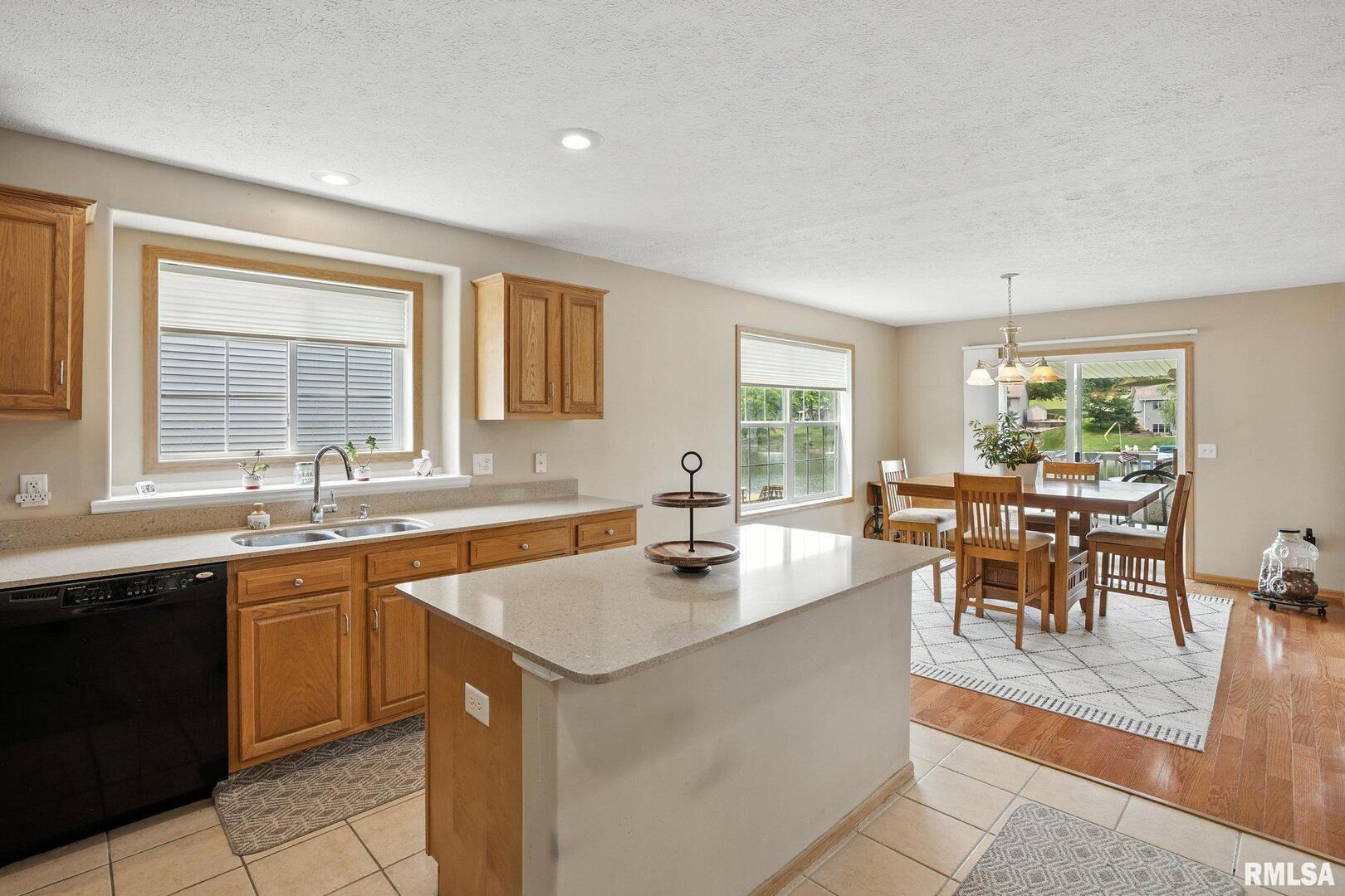106 Valley View Drive Sherrard, IL 61281 - Photo 14 of 35 a dining hall with stainless steel appliances granite countertop a sink and a large window