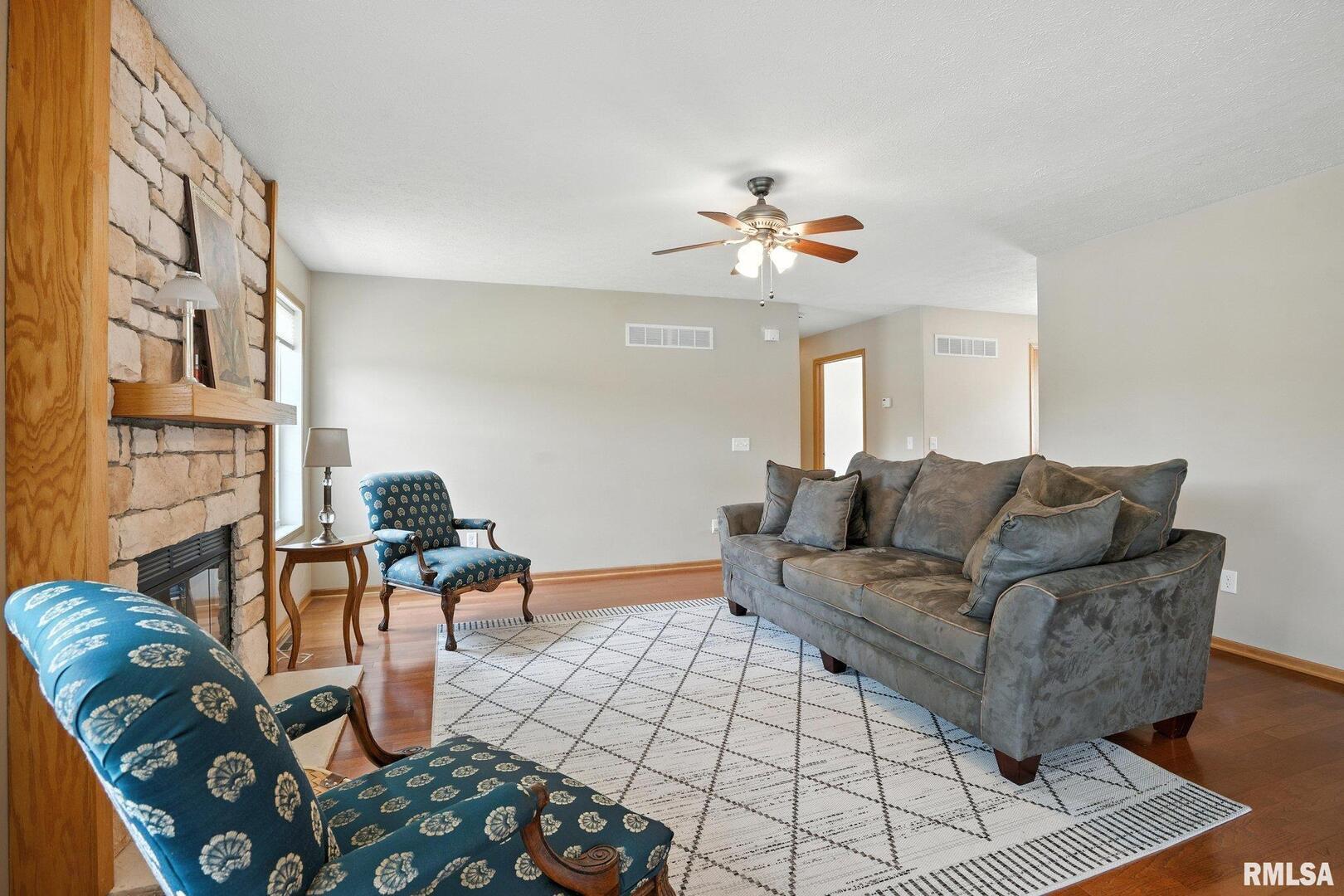 106 Valley View Drive Sherrard, IL 61281 - Photo 8 of 35 a living room with furniture a couch and a chandelier