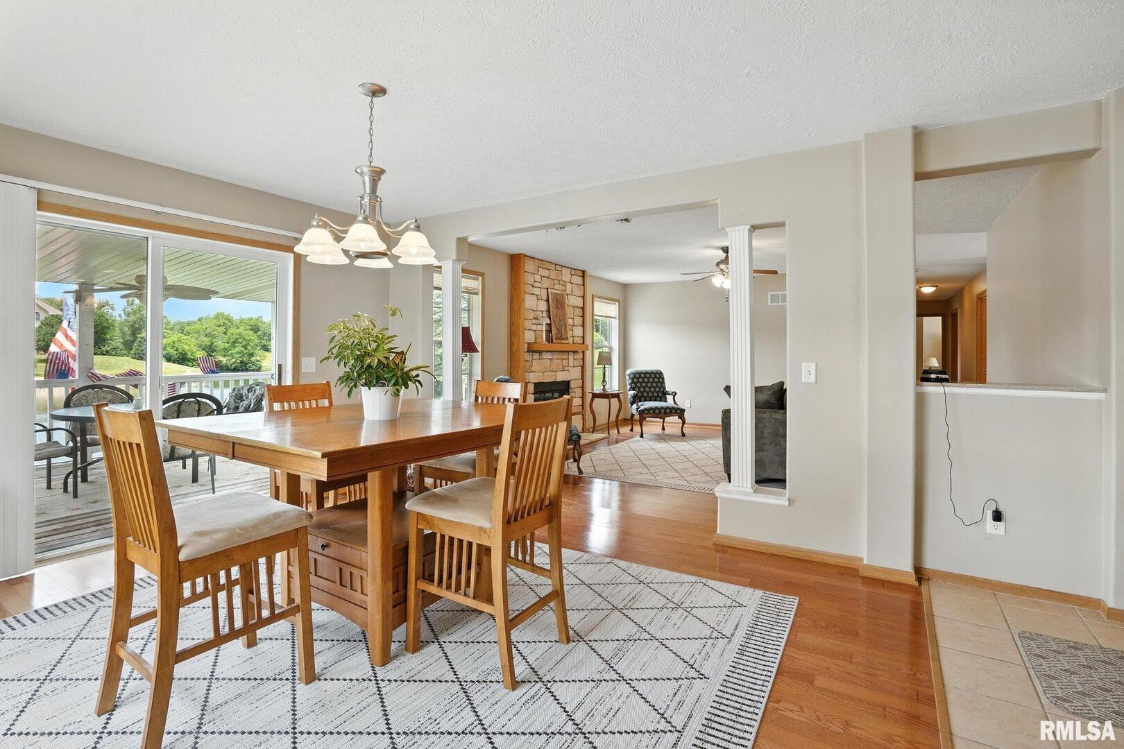 106 Valley View Drive Sherrard, IL 61281 - Photo 10 of 35 a dining room with furniture a chandelier and wooden floor