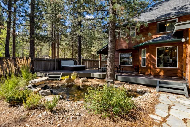 a view of a house with a yard and sitting area