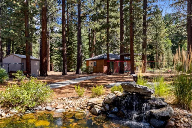 a view of a swimming pool with lawn chairs under an umbrella