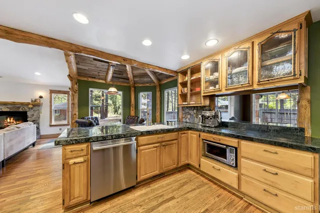 a kitchen with granite countertop a sink and cabinets