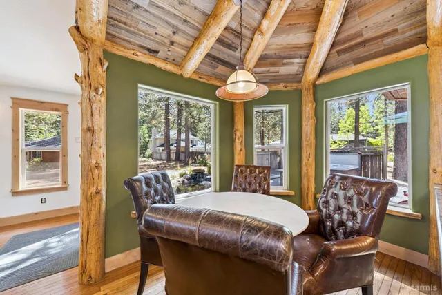 a view of a dining room with furniture large windows and wooden floor
