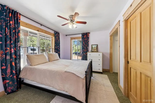 a bedroom with a large bed and a chandelier