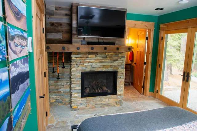 a living room with a fireplace and a flat screen tv