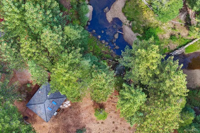 an aerial view of a house with a yard