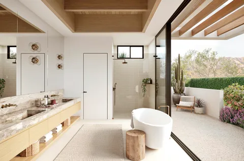 a spacious bathroom with a double vanity sink a toilet a mirror and shower