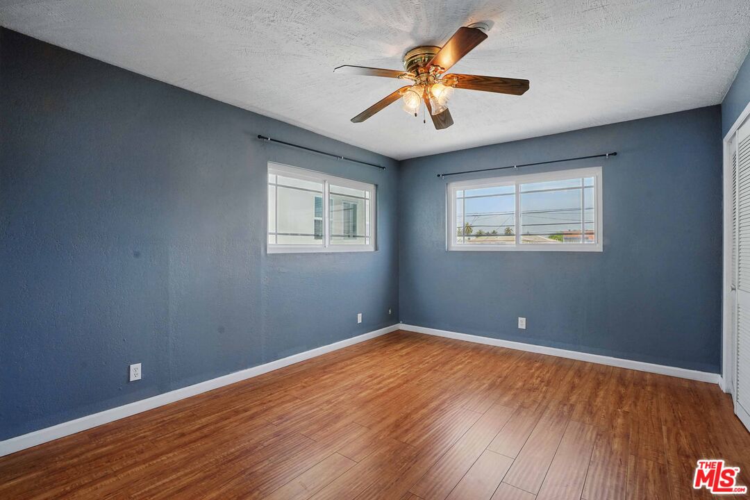 2108 Hauser Boulevard Los Angeles, CA 90016 - Photo 19 of 23 an empty room with wooden floor and windows