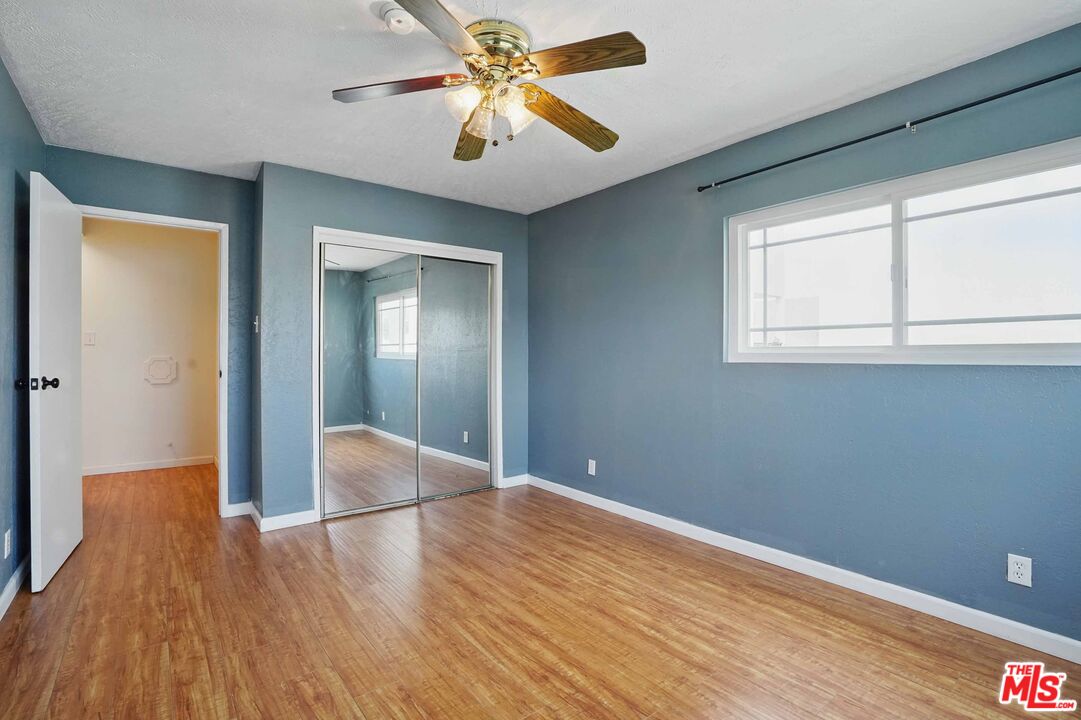2108 Hauser Boulevard Los Angeles, CA 90016 - Photo 20 of 23 wooden floor in an empty room with a window