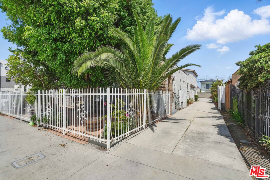 2108 Hauser Boulevard Los Angeles, CA 90016 - Photo 2 of 23 a view of a pathway with a wrought fence