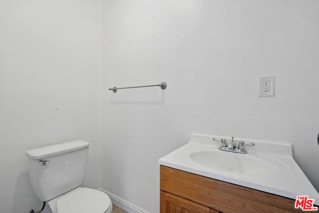 2108 Hauser Boulevard Los Angeles, CA 90016 - Photo 5 of 23 a bathroom with a sink a toilet and mirror