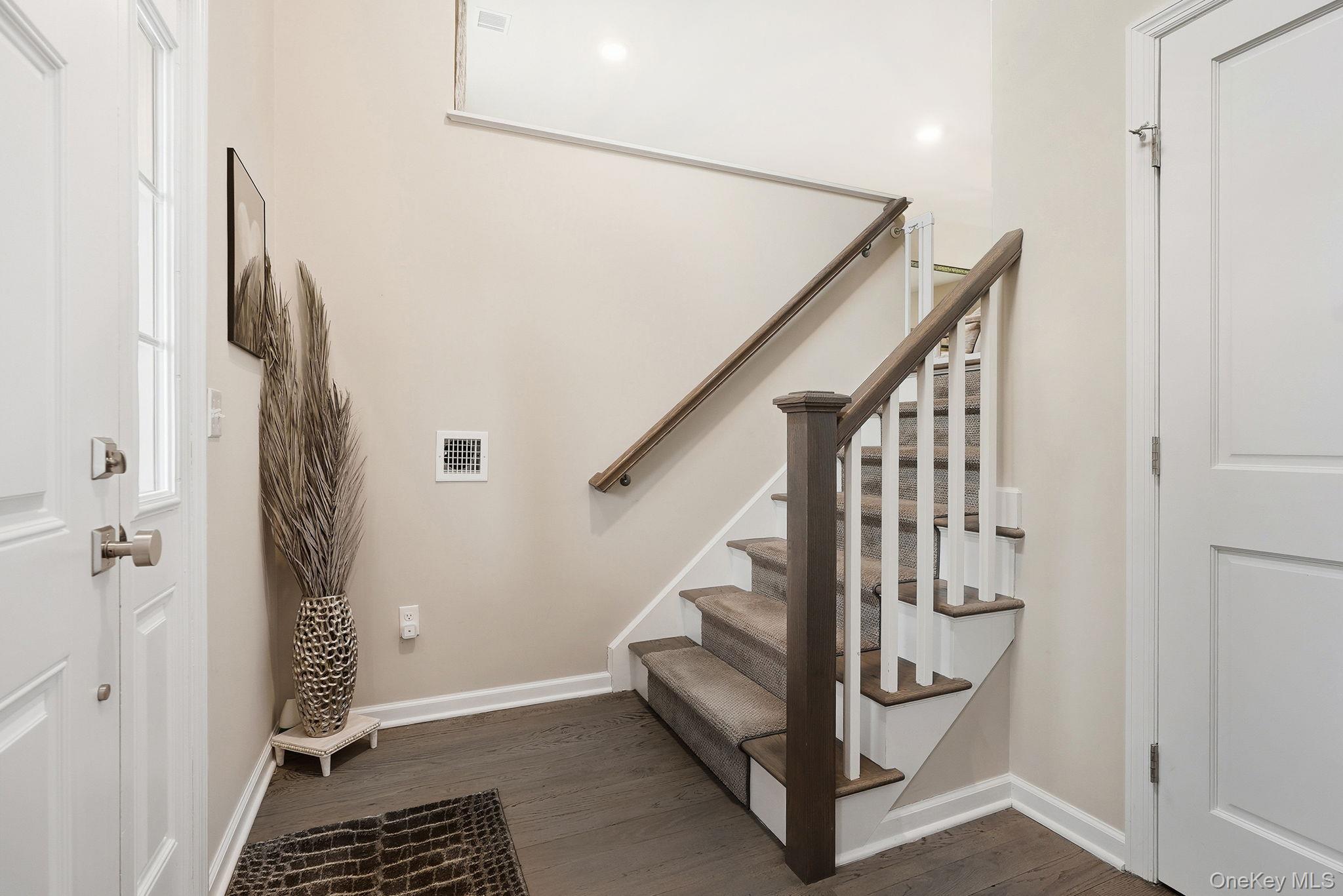 8 Muscoot River Road Granite Springs, NY 10527 - Photo 5 of 40 Entryway featuring wood-finish flooring, a staircase with carpeted treads and wood handrail