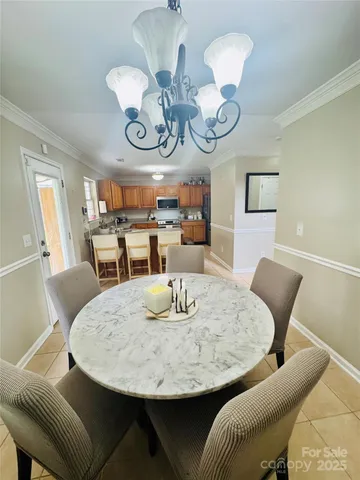 a view of a dining room with furniture and chandelier
