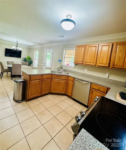 a kitchen with a sink and a stove top oven