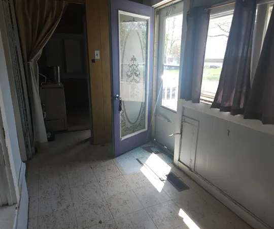 a view of an empty room with a fireplace