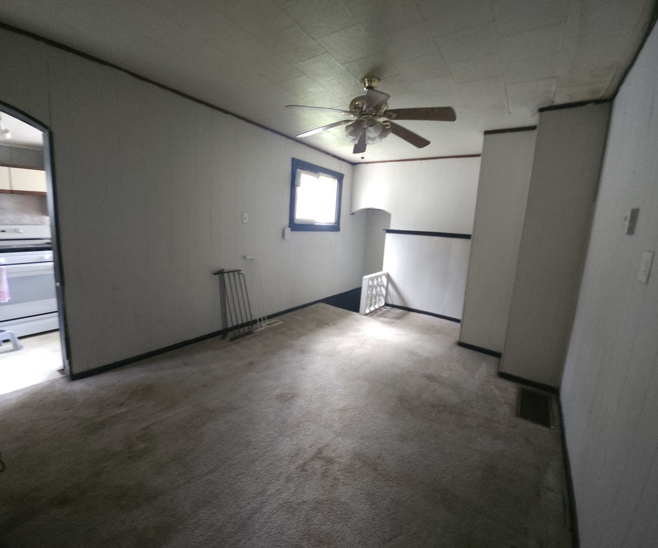 303 South Spruce Street Villa Grove, IL 61956 - Photo 6 of 10 an empty room with windows and fan