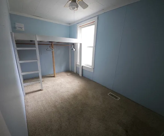 an empty room with a empty space and windows