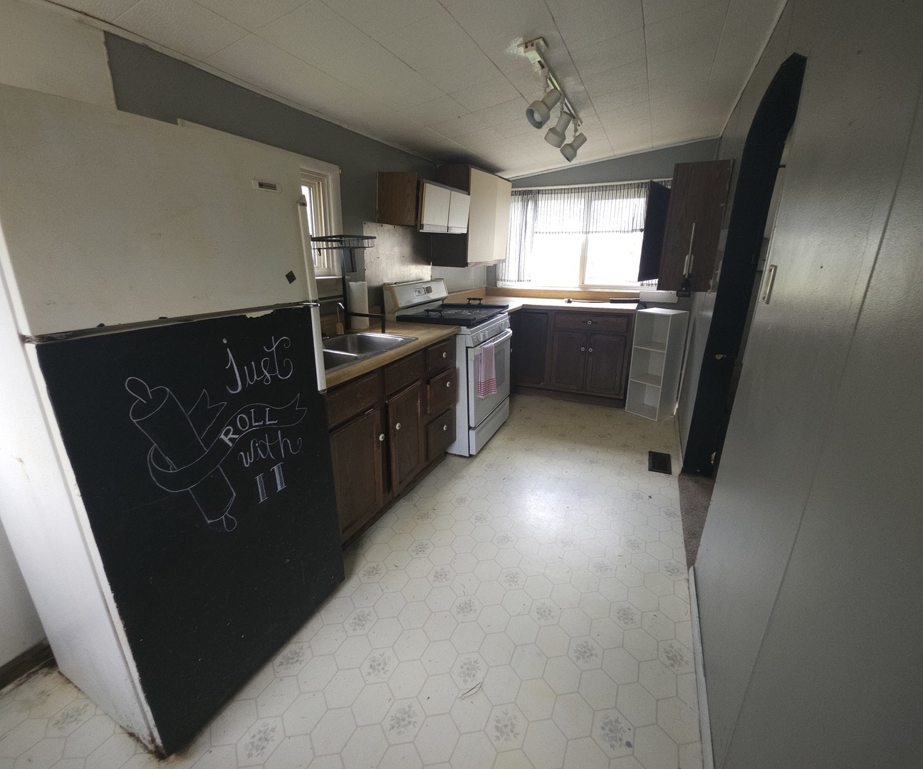 303 South Spruce Street Villa Grove, IL 61956 - Photo 9 of 10 a kitchen with stainless steel appliances granite countertop a refrigerator a sink a stove a microwave a sink and dishwasher