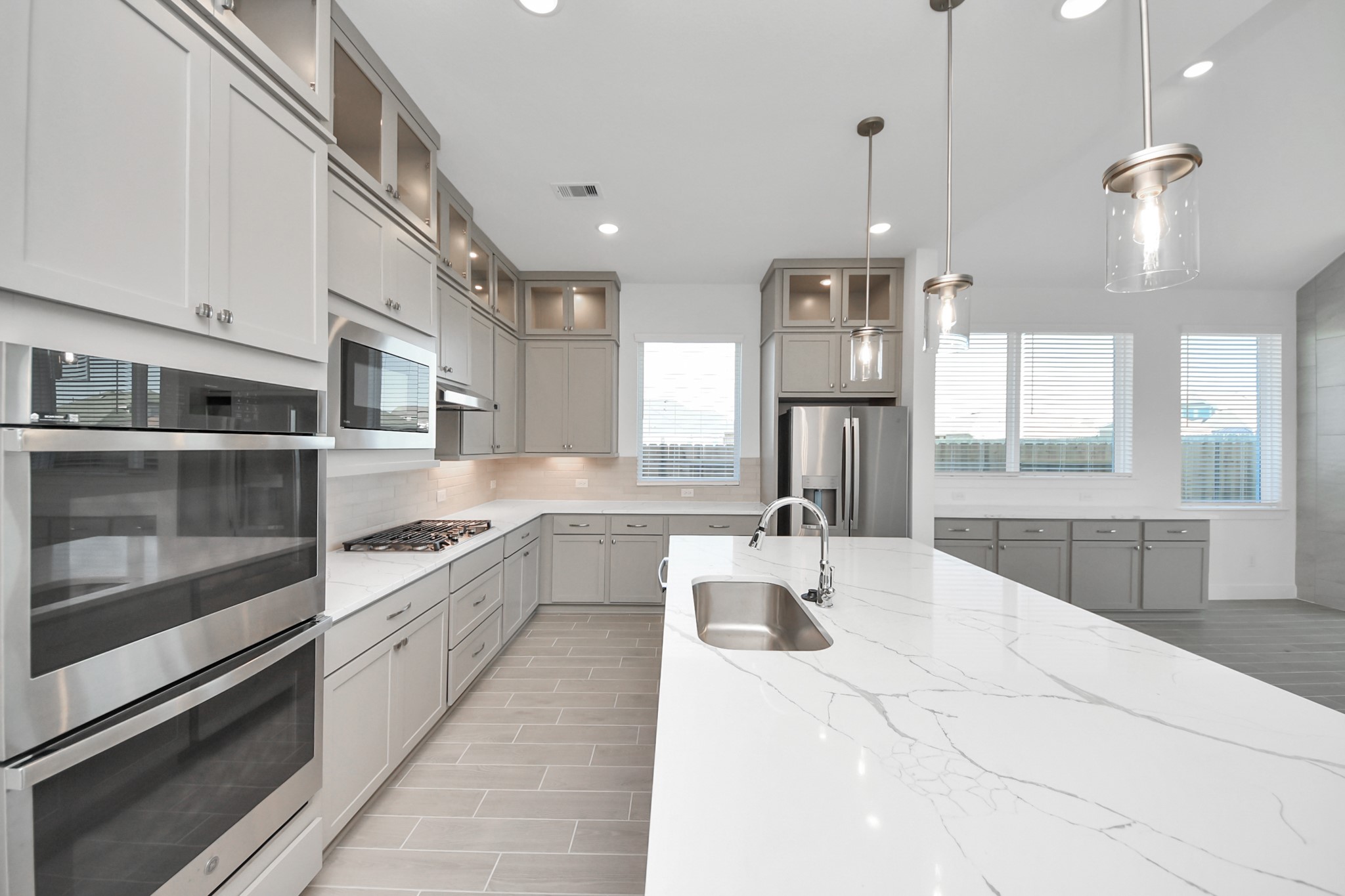 9507 Chateau Hill Manvel, TX 77578 - Photo 6 of 32 a large white kitchen with lots of counter space wooden floor and appliances