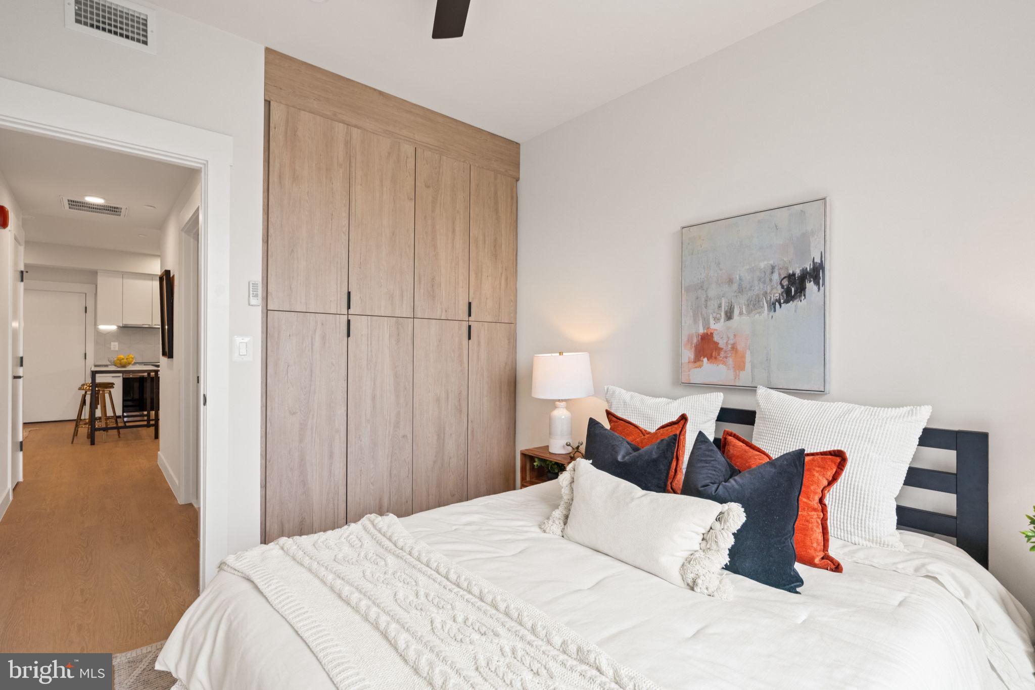 733 8th Street Southeast, Unit 2 Washington, DC 20003 - Photo 7 of 17 a bedroom with a bed and a chair