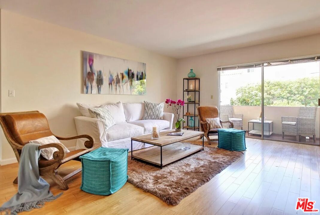 852 17th Street, Unit 3 Santa Monica, CA 90403 - Photo 3 of 8 a living room with furniture and a large window