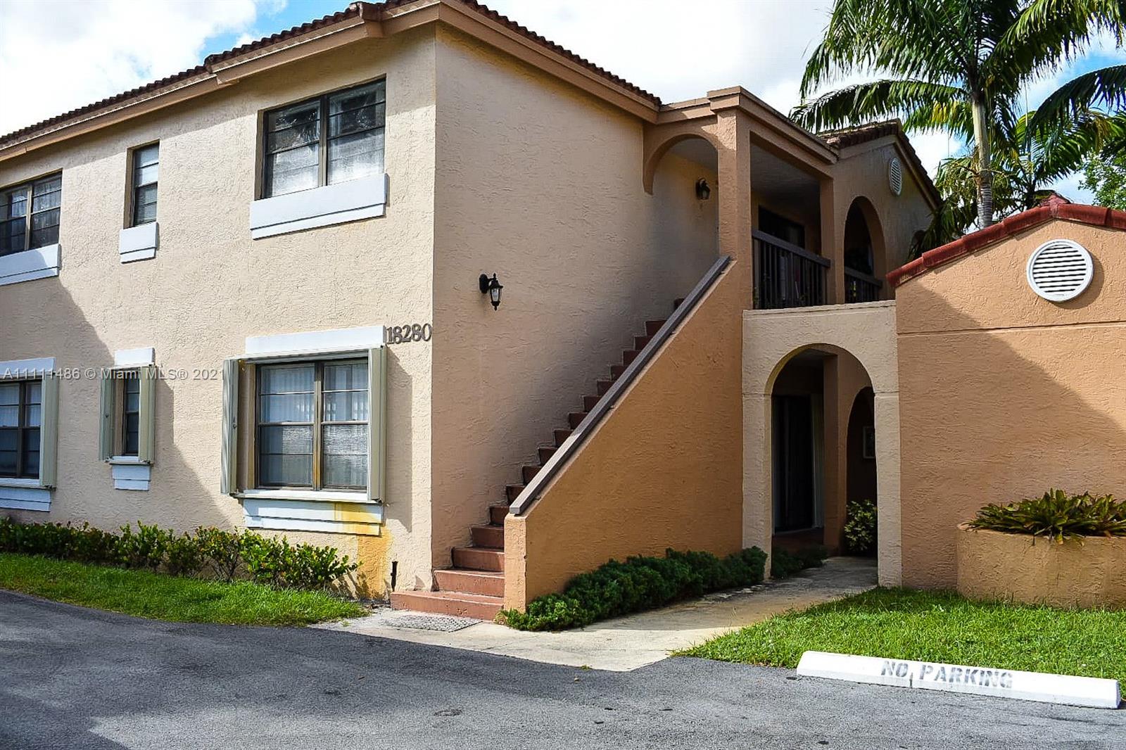 18280 Mediterranean Boulevard, Unit 43 Hialeah, FL 33015 - Photo 2 of 28 a front view of a house with garden