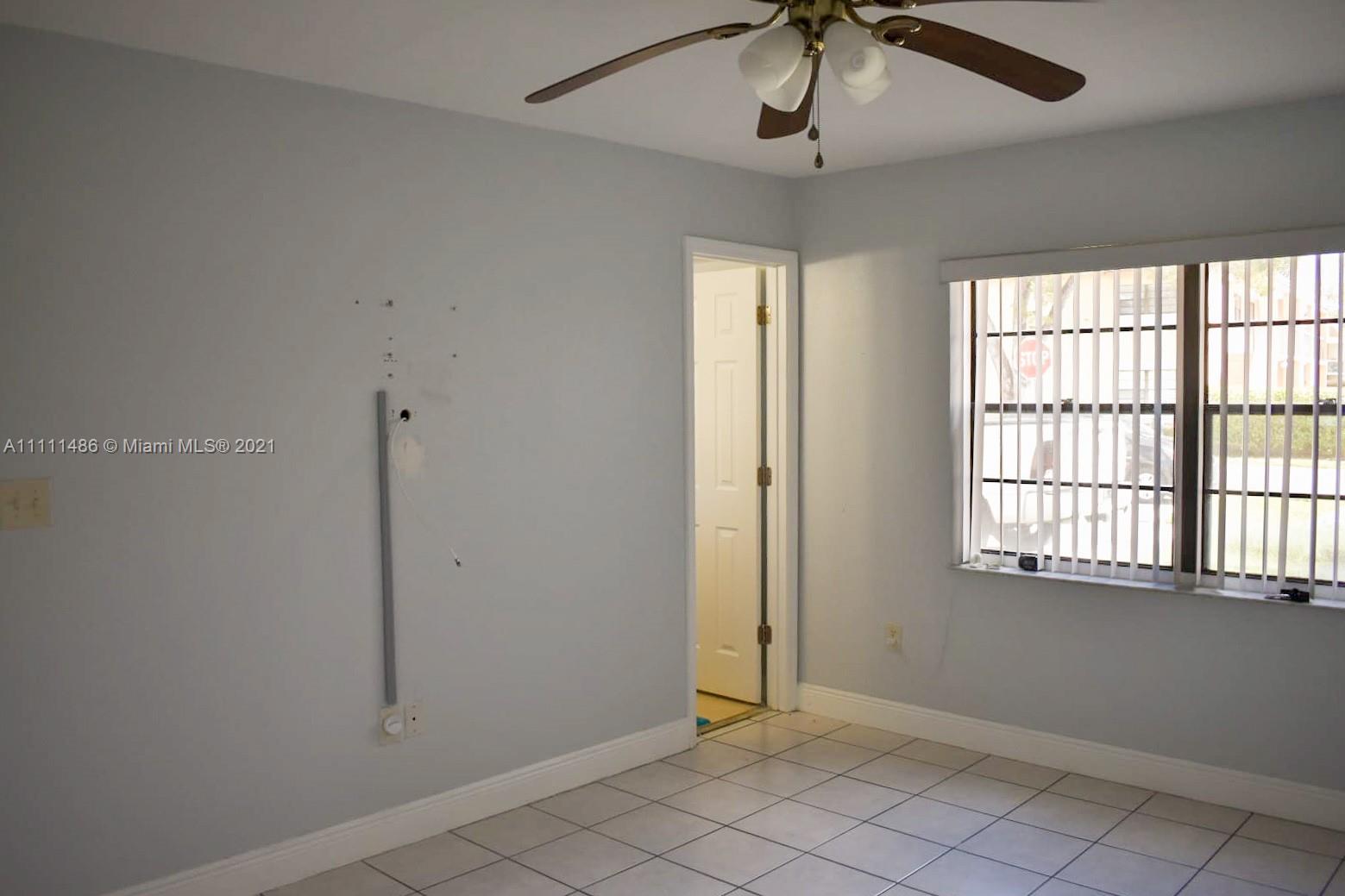 18280 Mediterranean Boulevard, Unit 43 Hialeah, FL 33015 - Photo 15 of 28 a view of an empty room with a window